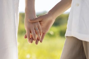side view people holding hands